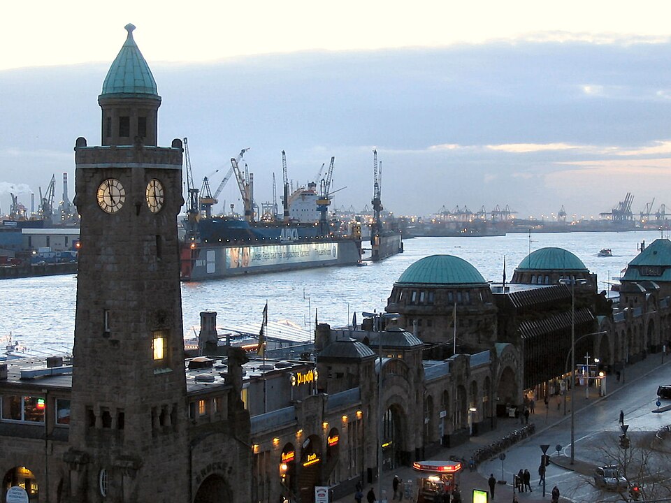 St. Pauli Landungsbrücken with clock tower and harbour in the evening